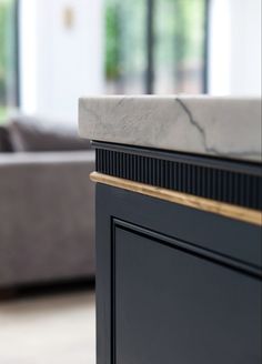 a close up of a black cabinet with marble top