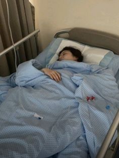 a woman is laying in a hospital bed