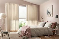 a bedroom with pink walls and white curtains