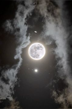 an image of the moon in the sky with clouds around it and two planets above