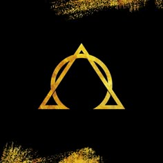 an image of a golden triangle on a black background with gold paint splatters