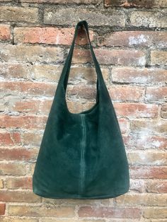 LARGE slouch leather bag in dark GREEN. Natural genuine SUEDE leather. NOT LINED. Dark green shopper bag.  Soft suede carry all bag.  Comfortable to carry due to the wide soft strap. Large enough for most tables and small computers, also to carry books or notebooks. THE COLOR CORRESPONDS BETTER TO THE FIRST PICTURES, The bag is closed by a metal clip at the center.  Width : 42cm - 16,5 in Height at the center: 34 cm - 13, 5 inc Total height : 65,5 cm  - 26 inch This bag in different colors and o Green Leather Tote Hobo Bag, Green Leather Hobo Tote Bag, Suede Lined Hobo Tote Bag For Shopping, Green Soft Leather Hobo Bag For Shopping, Casual Green Soft Leather Hobo Bag, Green Leather Hobo Bag Casual Style, Green Suede Bags For Everyday Use, Green Suede Shoulder Bag For Everyday Use, Tote Leather Bag