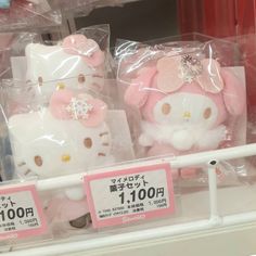 hello kitty stuffed animals are for sale at a store in japan, with price tags on them