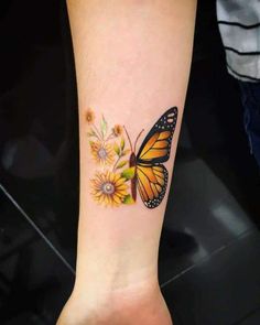 a yellow butterfly with sunflowers on the wrist