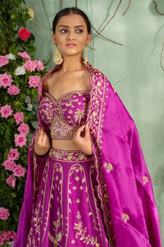 Purple lehenga with zardozi hand embroidery in floral, Mughal motifs and scallop pleated hem. Paired with an off-shoulder blouse and an embroidered dupatta.
Component: 3
Pattern: Embroidered
Type Of Work: Zardozi work
Neckline: Off-shoulder
Sleeve Type: Full sleeves
Fabric: Silk, Satin organza
Color: Purple
Other Details: 
Scallop pleated lehenga hem
V-back blouse
Closure:
Blouse: Back concealed hooks
Occasion: Wedding, Reception - Aza Fashions Navratri Raw Silk Sets With Zari Work, Transitional Dola Silk Choli With Resham Embroidery, Transitional Dola Silk Sets With Intricate Embroidery, Dola Silk Sets With Zari Work For Reception, Bollywood Dola Silk Sets With Zari Work, Bollywood Style Dola Silk Set With Zari Work, Chinon Sets With Zari Work For Receptions, Bollywood Dola Silk Sets With Intricate Embroidery, Bollywood Style Dola Silk Sets With Intricate Embroidery