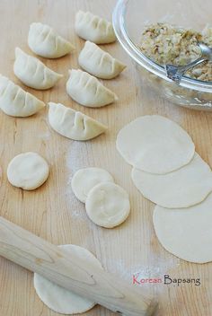 some dumplings are being prepared on a wooden table