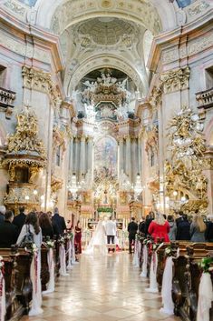 the bride and groom are walking down the aisle at their wedding ceremony in an ornate church