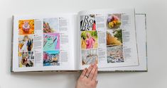 an open book with pictures on it being held by a person's hand over the page