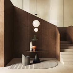 a room with some stairs and a table on the floor in front of two vases