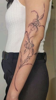 a woman with a flower tattoo on her arm