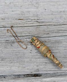 an old corked umbrella is sitting on the wooden floor next to it's string