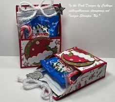 two christmas gift bags with candy in them