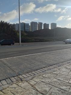 an empty street with cars parked on the side