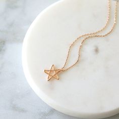 "Beautiful and lovely rose gold pentagram little star charm necklace. Made of rose gold plated tiny pentagram star charm with skinny rose gold chain. Soft and warm looking dainty necklace is good for yourself or gift ! Your necklace will ship in a rudiana gift box. * Rose Gold Plated over Brass * Necklace Length 15\"-20\" * Star Charm 1/2\" * Creation Time : 1 - 3 days * US shipping transit time : 3-5days * International shipping normally takes 7-14days ♥ See more Rudiana Accessories Rudiana.ets Dainty Star Of David Charm Necklace With Delicate Chain, Minimalist Rose Gold Star Charm Jewelry, Rose Gold Star Charm Pendant Necklace, Delicate Star Charm Necklace For Gift, Rose Gold Pendant Necklace With Star Charm, Dainty Star Of David Charm Necklace For Gift, Minimalist Star Charm Necklace As Gift, Delicate Star Of David Necklace For Gift, Minimalist Star Charm Necklace For Gift