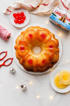 a pineapple upside down cake with cherries on the top and other decorations around it