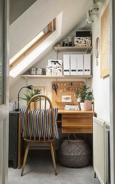 a room with a chair, desk and shelves in it