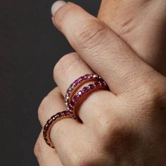 The lustrous deep red ruby gems set into this satisfyingly heavy gold band, are said to represent happiness, passion, vitality and vigor. These gleaming Ruby bands can be worn on their own or as part of a stacked collection of heirloom pieces for a different look every day. These bands also make the perfect birthstone gift for any July Babies! - 3 mm wide French pave band - Approx 22 Ruby stones based on size 7, weighing 3cts - Select from 14K or 18K gold, in yellow, rose or white color or plati Ruby Eternity Band, Engagement Necklaces, Ruby Bands, All Band, Pave Band, Birthstone Gifts, Ruby Stone, Charm Rings, Red Ruby