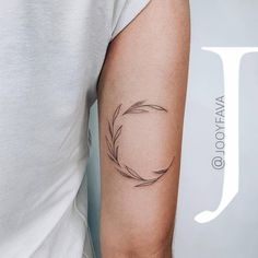 a woman's arm with a tattoo on it that has a circle in the middle