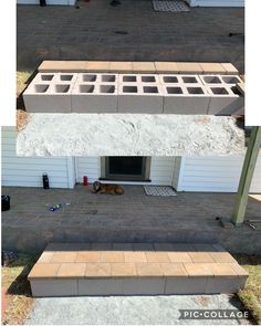 a dog laying on the ground in front of a house