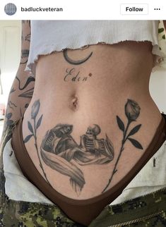 a woman's stomach with tattoos on it