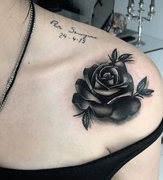 a woman with a rose tattoo on her shoulder