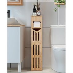 a bathroom with a toilet, sink and wooden shelf next to the toilet in it