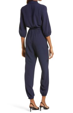 The jumpsuit trend is, well, hopping, and this option, styled with an easy tied waist and elastic cuffs, is a winning way to wear the look. 58" length; 30" inseam; 10" leg opening (size Medium) Front button-and-loop closure Surplice V-neck with spread collar Long sleeves Elastic cuffs and waist Front slant pockets Removable tie belt Partially lined 100% polyester Hand wash, line dry Made in the USA Women's Clothing Relaxed Fit Jumpsuit With Elastic Waistband For Loungewear, Tie Waist Jumpsuits And Rompers For Loungewear, Tie Waist Overall Jumpsuits And Rompers For Loungewear, Loungewear Jumpsuits With Tie Waist, Loungewear Jumpsuits And Rompers With Tie Waist, Overall Jumpsuits And Rompers With Elastic Waistband For Loungewear, Chic Jumpsuit With Elastic Waistband For Loungewear, Chic Jumpsuits And Rompers With Elastic Waistband For Loungewear, Chic Loungewear Jumpsuits With Elastic Waistband