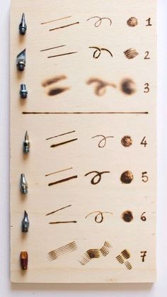 a wooden board with different types of nails on it