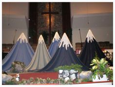 three blue and white tents sitting on top of a table in front of a window