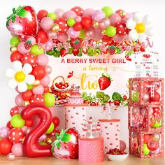 a strawberry sweet girl birthday party with balloons and decorations