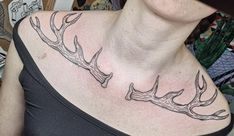 a woman with a deer antlers tattoo on her chest