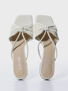 Editor's NotesBLUEVINE's shoes are feminine and perfect for everyday wear.- Light-weighted- Eye-catching ribbon detail- Easy slide-on design- Non-slip rubber outsole- Minimal styleMeasurements(in.)- Size: KR 220MM (US 5) ~ KR 255MM (US 8.5)- Height: 0.59in.*Fits true to size.Composition & Care- Lambskin- Insole: Synthetic Leather- Rubber Sole- Avoid direct heat and moisture- Professional cleaning is recommendedDesigner- by BLUEVINE White Flat Mules With Rubber Sole, Chic White Mules With Rubber Sole, White Slip-on Heels With Rubber Sole, White Heels With Rubber Sole, Chic White Heels With Rubber Sole, Chic White Sandals With Rubber Sole, Elegant Spring Slides With Rubber Sole, Spring Slip-on Heels With Bow, Spring Bow Heels Slip-on