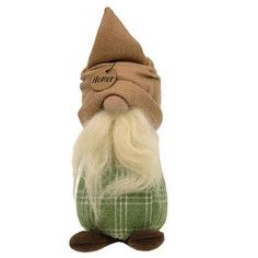 a small stuffed gnome with a green shirt and brown hat on it's head