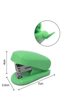 a green stapler sitting on top of a white table