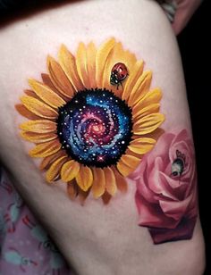 a woman's thigh with a sunflower painted on it and a pink rose