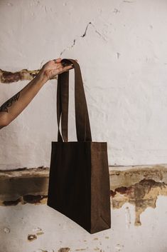 a person holding a brown bag in their hand