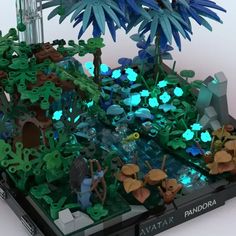 a lego model of a forest with trees and plants on it's side, surrounded by blue lights