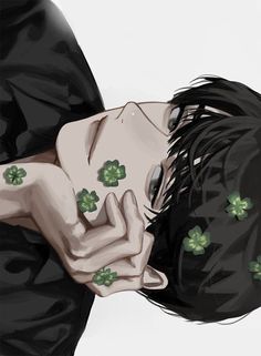 a man with black hair and green clovers on his chest is laying down in front of the camera