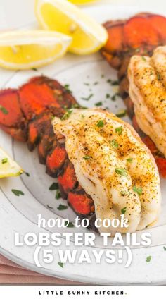 lobster tails on a plate with lemon wedges and parsley garnishes