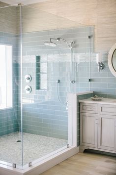 a bathroom with a shower, sink and mirror on the wall is shown in this image