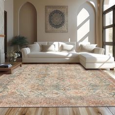 a living room filled with furniture and a large rug on top of a hard wood floor