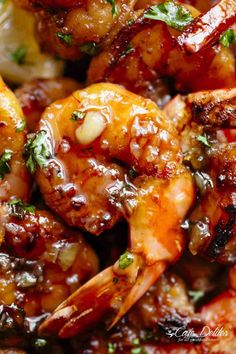 close up view of shrimp with sauce and herbs