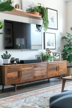 23 Stylish TV Wall Decor Ideas - DailyHomeSafety Mid Century Modern Living Room Tv Wall, Tv Cabinet With Floating Shelves, Walls In Living Room Decorating, Wall Shelves Under Tv, Living Room Wall With Tv Decor Ideas, Asymmetrical Tv Wall Decor, Floating Shelves Over Tv Living Rooms, Shelves And Art On Wall, Above Mounted Tv Decor