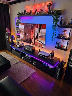 a living room filled with furniture and a flat screen tv mounted to the side of a wall