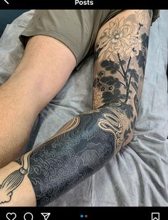 a man laying on top of a bed covered in tattoos