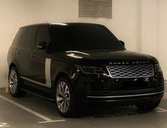 a black range rover parked in a parking space