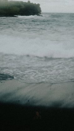 a man riding a surfboard on top of a wave in the ocean