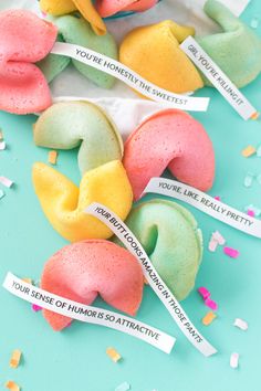 colorful donuts with words on them and confetti scattered around the doughnuts