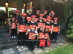 a group of people wearing red boxes on their heads