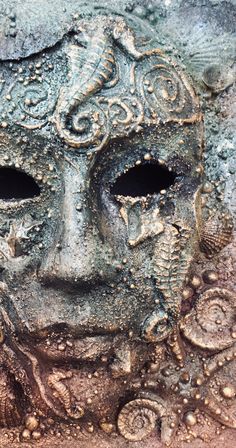 a close up of a mask with water drops on it